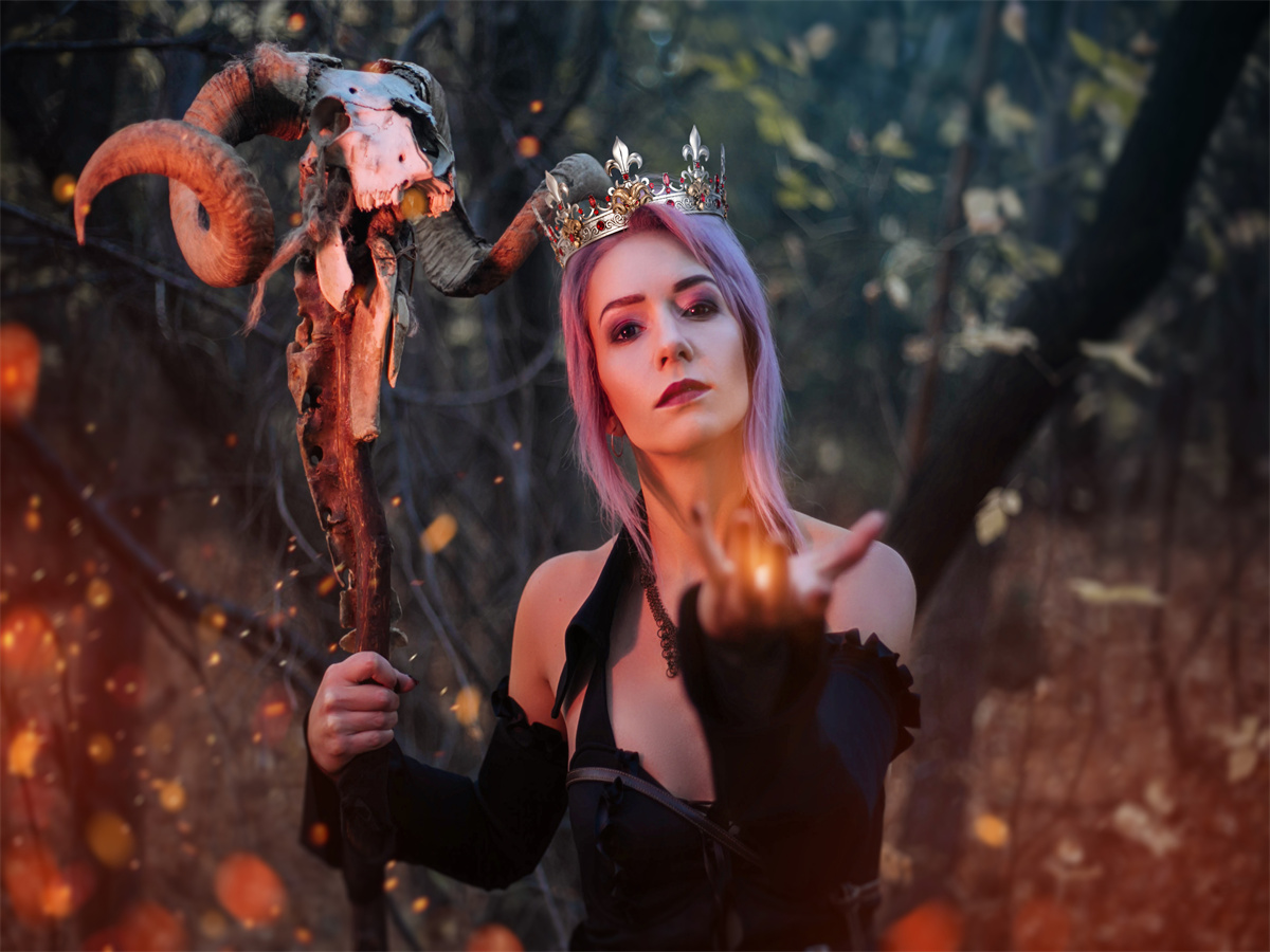 A witch with a goat's crown ready to cast a spell.